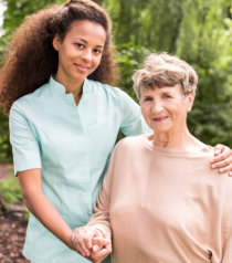 caregiver with an elderly woman, outdoors